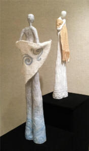 Two sculptures with handwoven accessories
