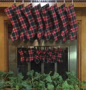 Handwoven tartan stockings hanging by the fireplace